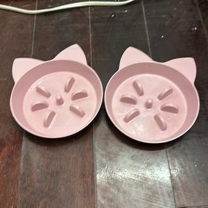 2 pink cat food bowls
